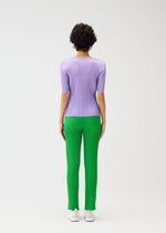 A model wears the PLEATS PLEASE ISSEY MIYAKE MONTHLY COLORS APRIL trousers.