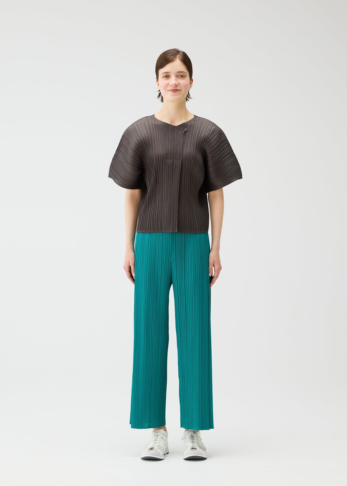 A model wears the PLEATS PLEASE ISSEY MIYAKE MONTHLY COLORS : JUNE monthly-colors-june-trousers-charcoal-1.