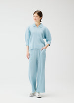 A model wears the PLEATS PLEASE ISSEY MIYAKE COTTON DENIM trousers.
