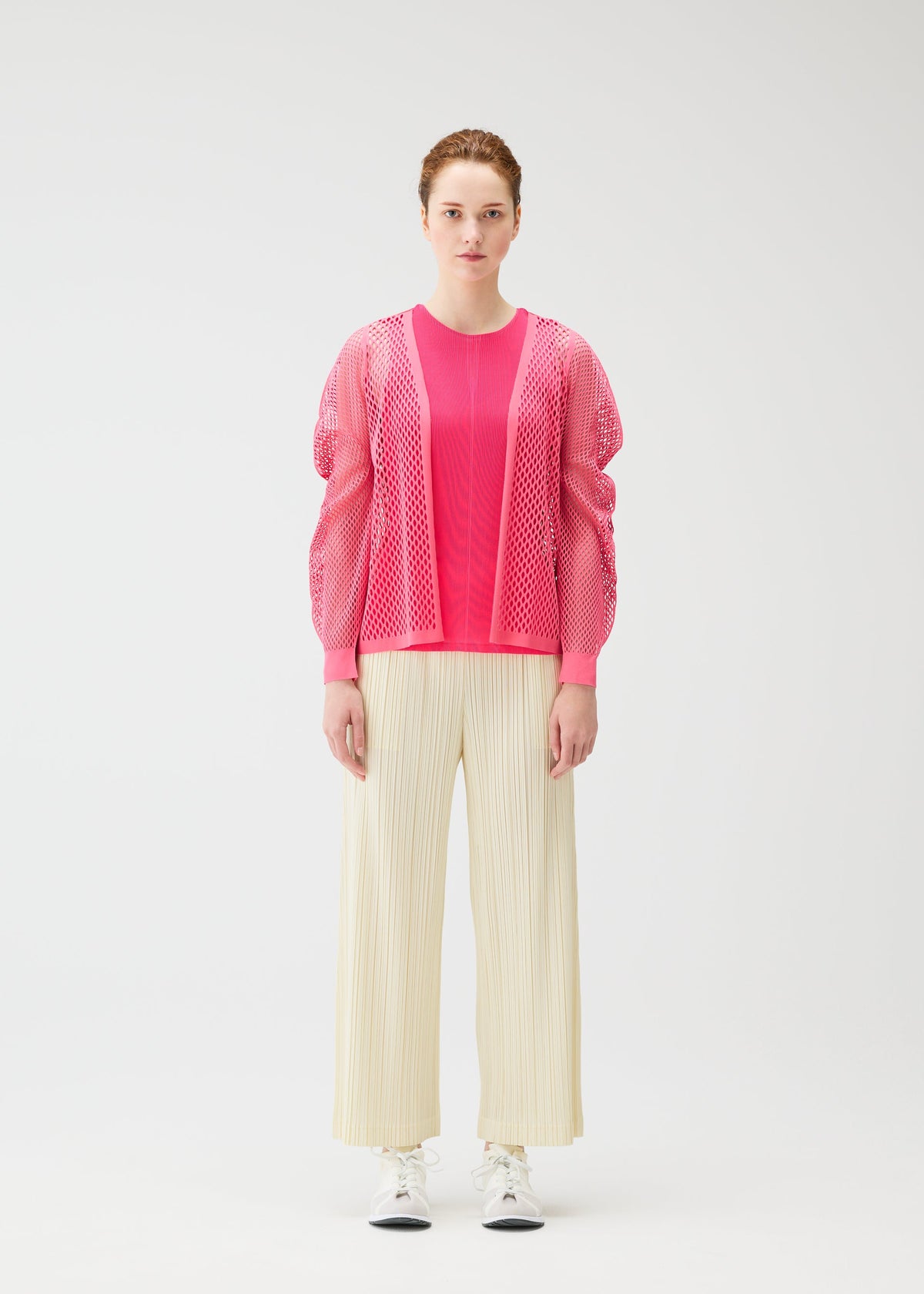 A model wears the PLEATS PLEASE ISSEY MIYAKE OPAQUE BOTTOMS opaque-bottoms-trousers-charcoal.