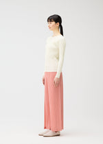A model wears the PLEATS PLEASE ISSEY MIYAKE RAMIE PLEATS trousers.