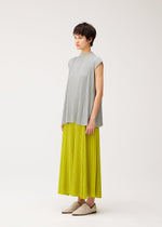 A model wears the PLEATS PLEASE ISSEY MIYAKE MELLOW PLEATS trousers.