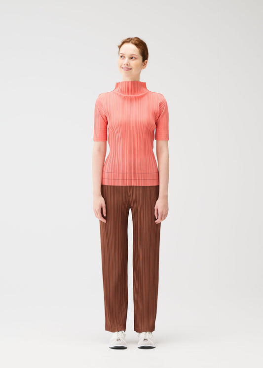 A model wears the PLEATS PLEASE ISSEY MIYAKE THICKER BOTTOMS 2 trousers.