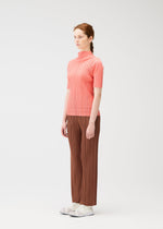 A model wears the PLEATS PLEASE ISSEY MIYAKE THICKER BOTTOMS 2 trousers.