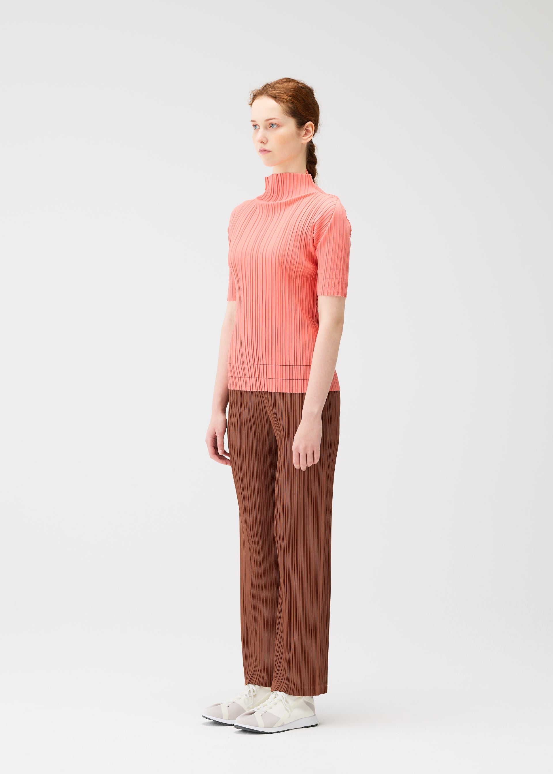 A model wears the PLEATS PLEASE ISSEY MIYAKE THICKER BOTTOMS 2 trousers.