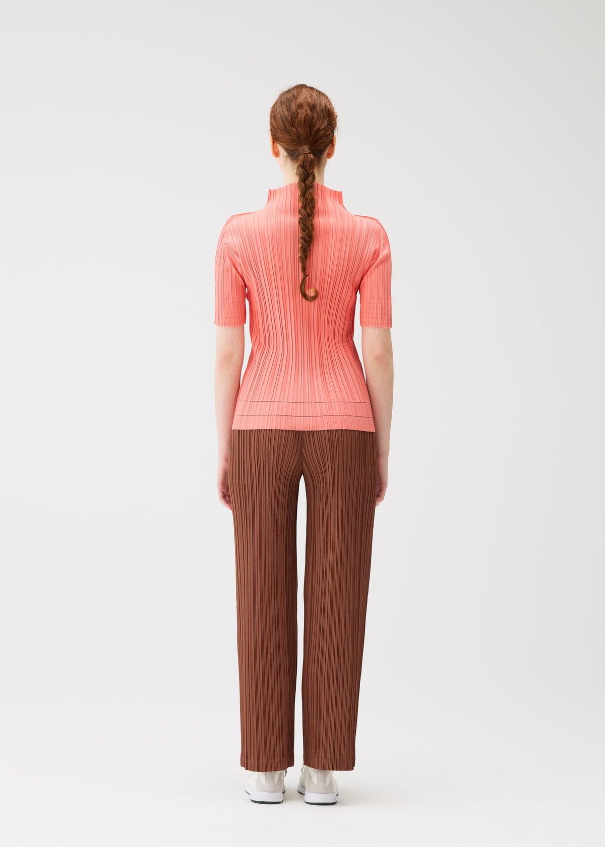 A model wears the PLEATS PLEASE ISSEY MIYAKE THICKER BOTTOMS 2 trousers.