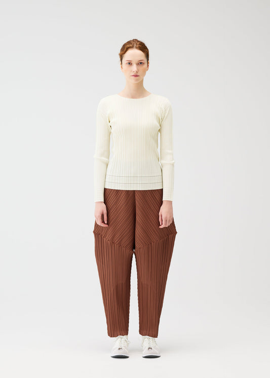 A model wears the PLEATS PLEASE ISSEY MIYAKE THICKER BOTTOMS 2 trousers.