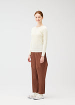 A model wears the PLEATS PLEASE ISSEY MIYAKE THICKER BOTTOMS 2 trousers.