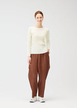 A model wears the PLEATS PLEASE ISSEY MIYAKE THICKER BOTTOMS 2 trousers.