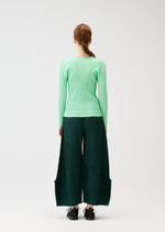 A model wears the PLEATS PLEASE ISSEY MIYAKE THICKER BOTTOMS 2 trousers.
