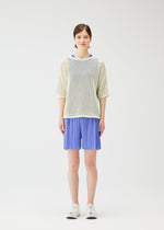 A model wears the PLEATS PLEASE ISSEY MIYAKE LOOP BOTTOMS shorts.