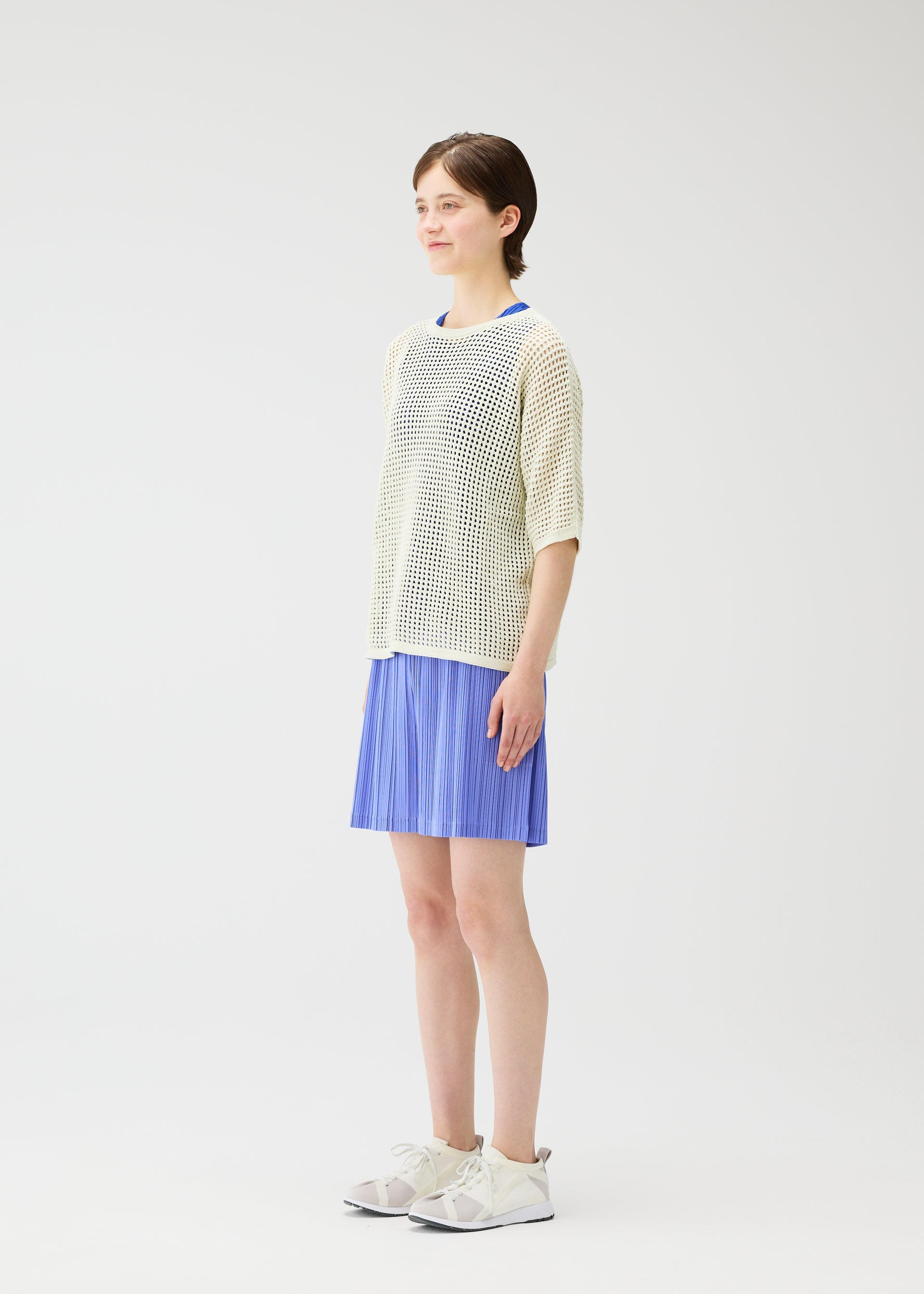 A model wears the PLEATS PLEASE ISSEY MIYAKE LOOP BOTTOMS shorts.
