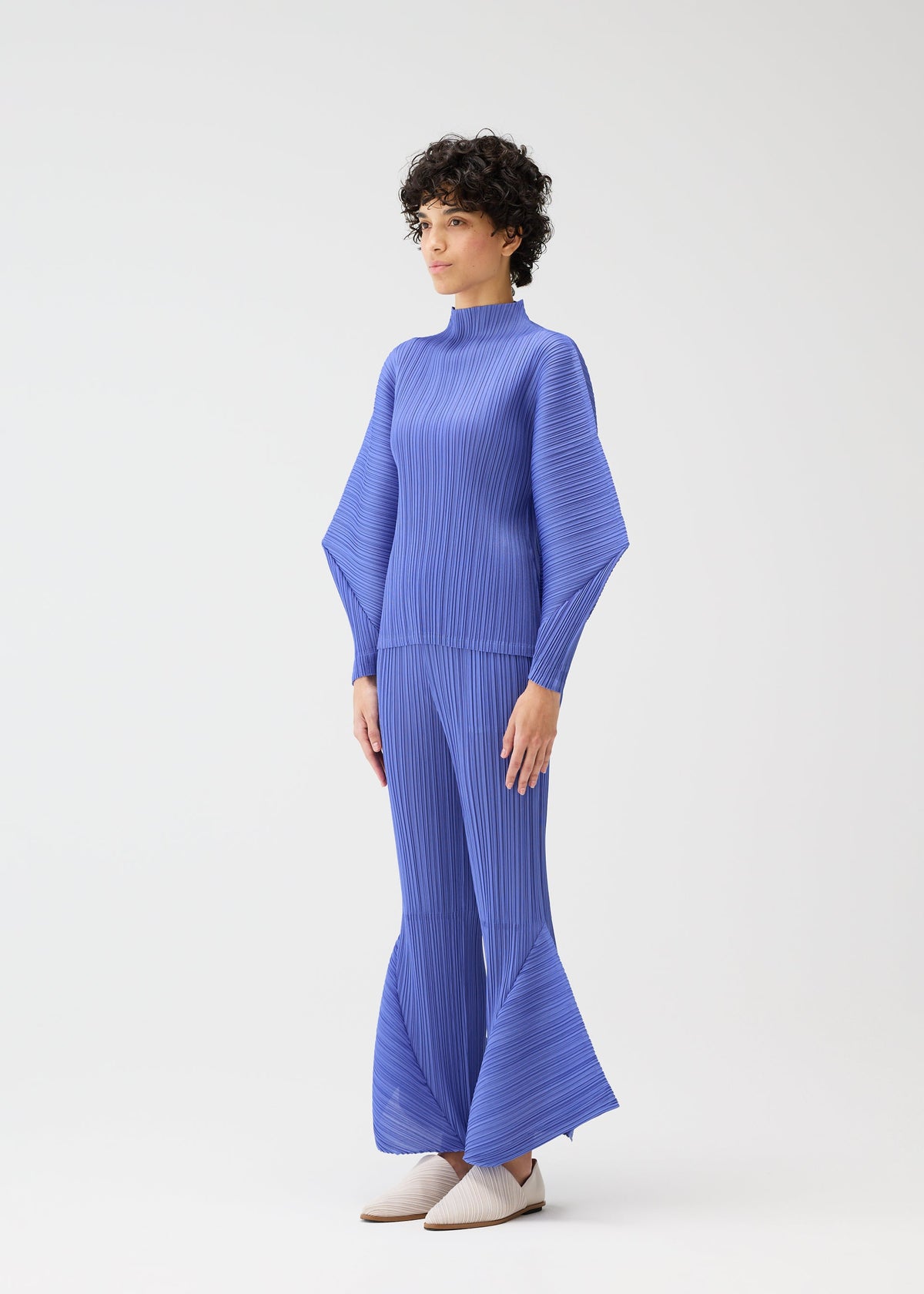 A model wears the PLEATS PLEASE ISSEY MIYAKE SKYLINE clothing.