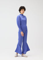 A model wears the PLEATS PLEASE ISSEY MIYAKE SKYLINE clothing.
