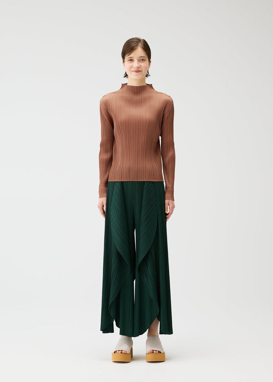 A model wears the PLEATS PLEASE ISSEY MIYAKE LEAF trousers.