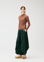 A model wears the PLEATS PLEASE ISSEY MIYAKE LEAF trousers.