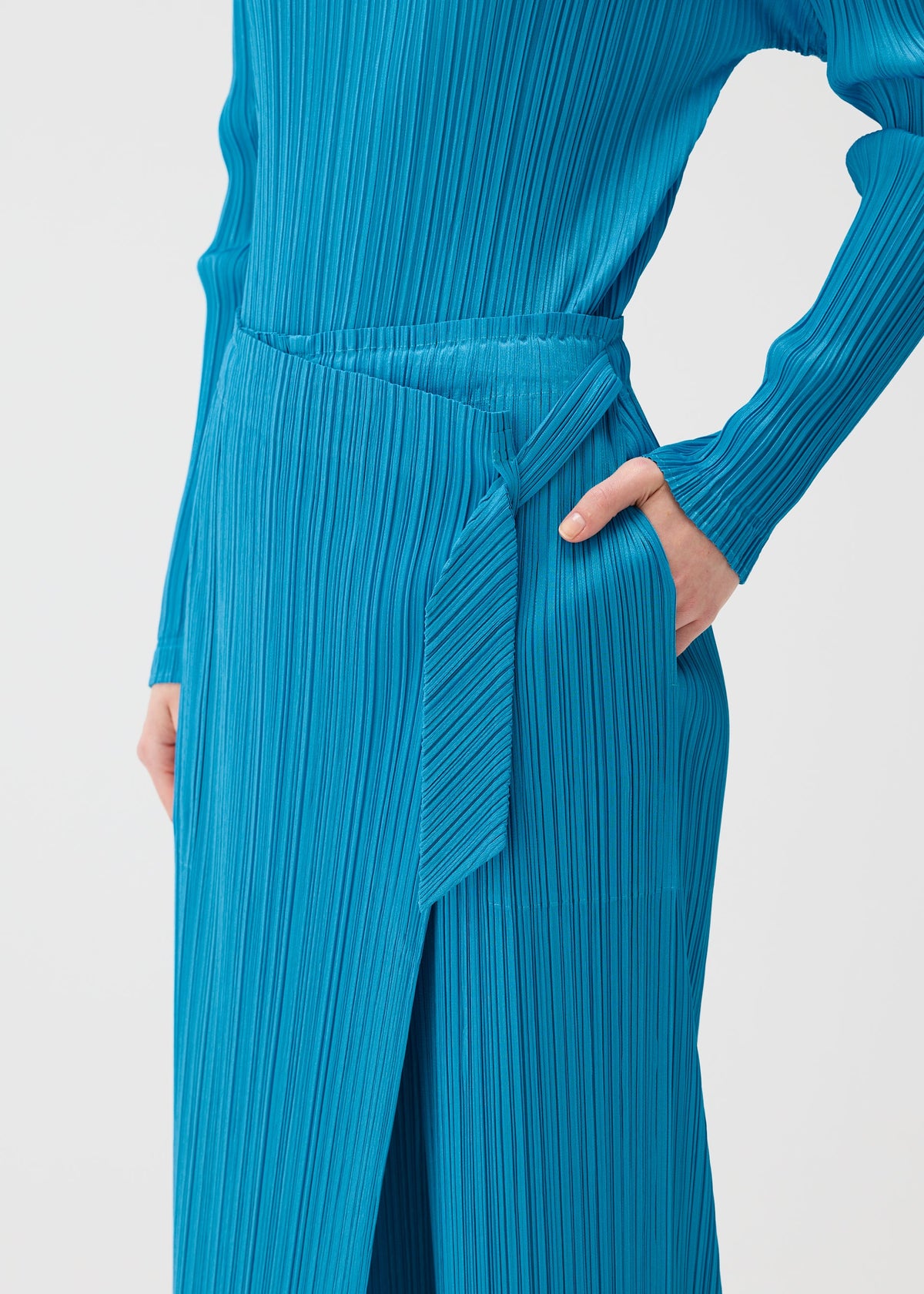 A model wears the PLEATS PLEASE ISSEY MIYAKE FACADE trousers.
