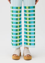 A model wears the PLEATS PLEASE ISSEY MIYAKE BUMPY BASKET bumpy-basket-trousers-pink.