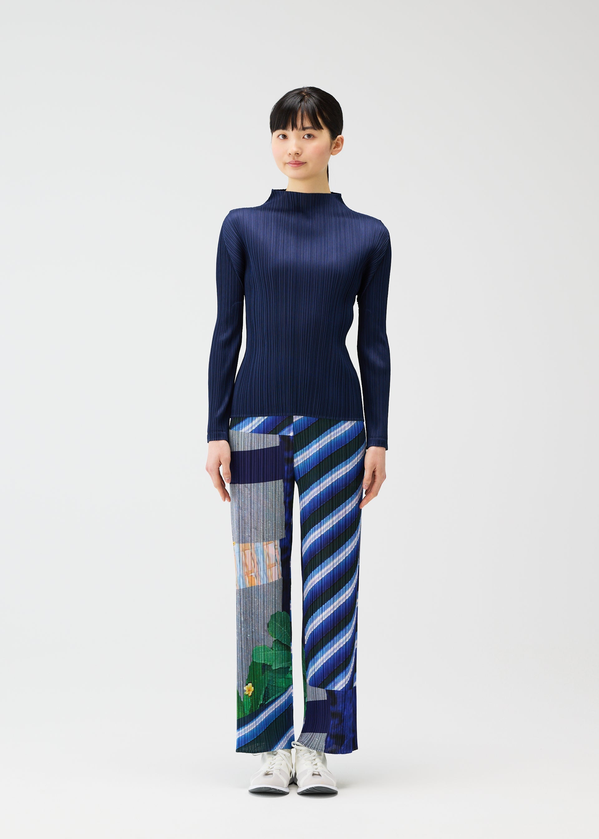 A model wears the PLEATS PLEASE ISSEY MIYAKE CITY COLLAGE clothing.