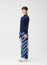 A model wears the PLEATS PLEASE ISSEY MIYAKE CITY COLLAGE clothing.
