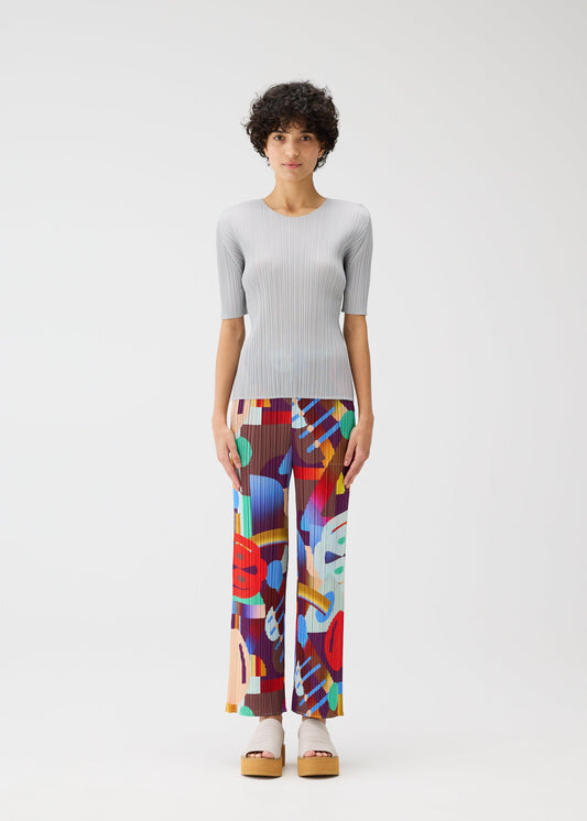 A model wears the PLEATS PLEASE ISSEY MIYAKE PLAYGROUND trousers.