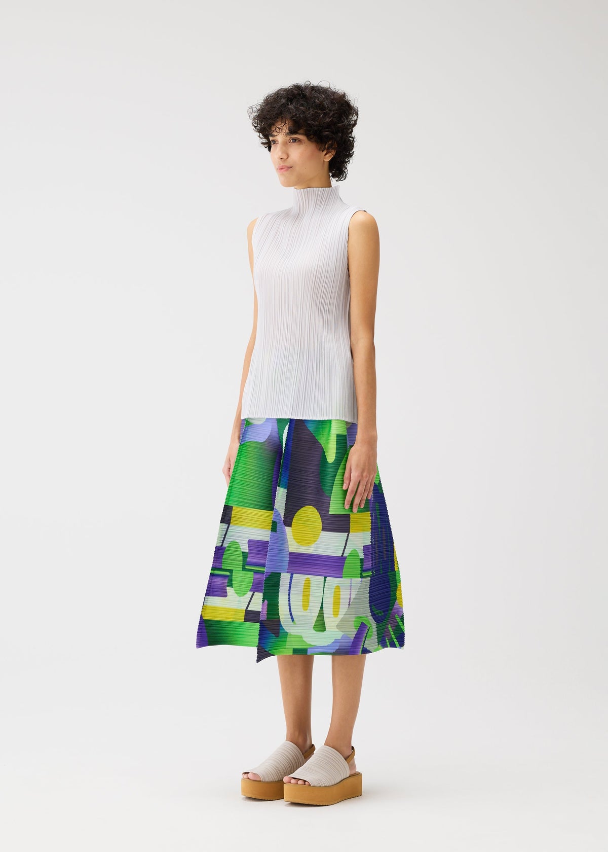 A model wears the PLEATS PLEASE ISSEY MIYAKE PLAYGROUND trousers.