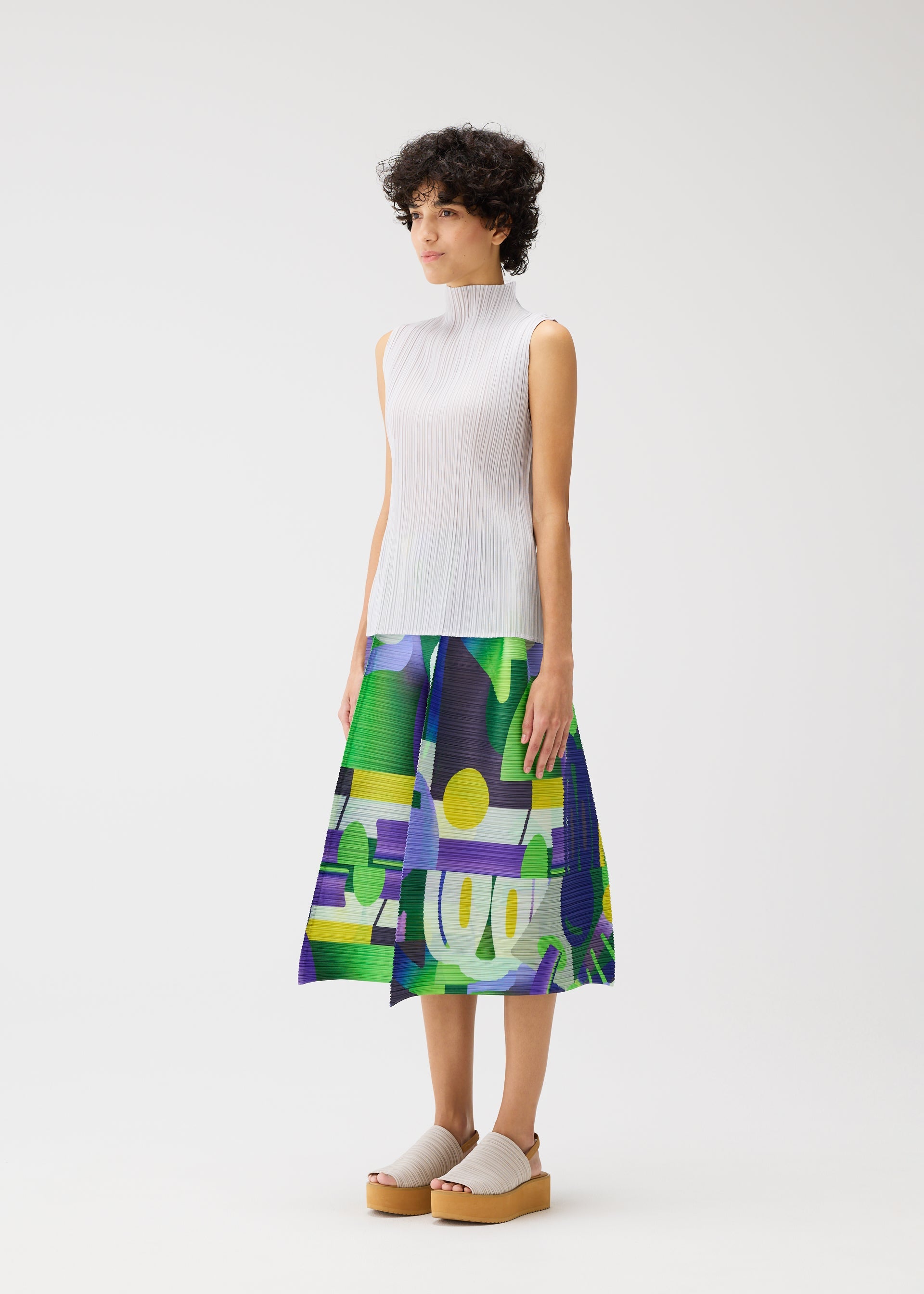 A model wears the PLEATS PLEASE ISSEY MIYAKE PLAYGROUND trousers.