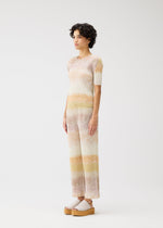 A model wears the PLEATS PLEASE ISSEY MIYAKE SEA BUBBLE trousers.
