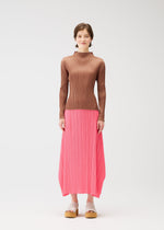 A model wears the PLEATS PLEASE ISSEY MIYAKE MONTHLY COLORS MARCH skirt.