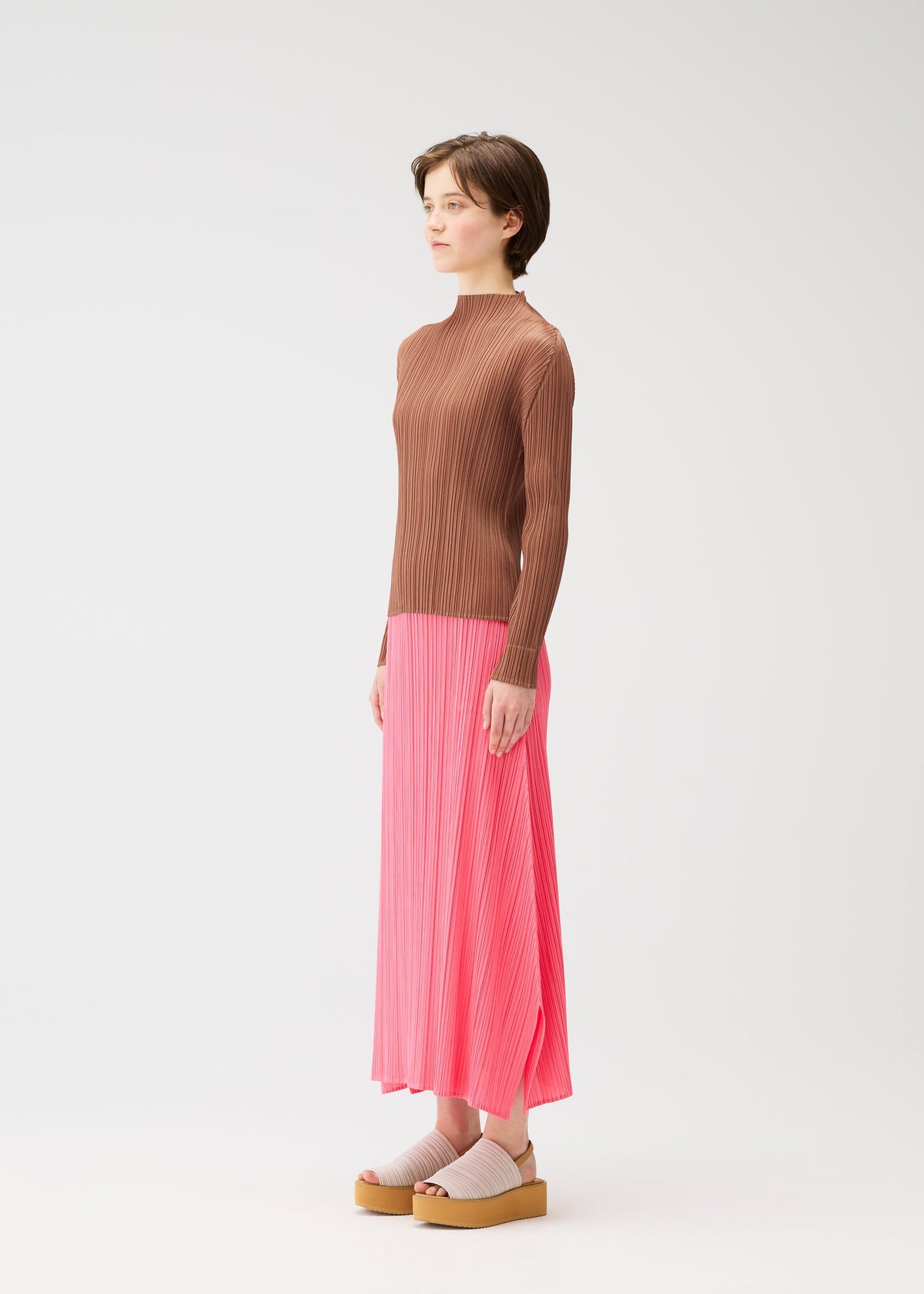 A model wears the PLEATS PLEASE ISSEY MIYAKE MONTHLY COLORS MARCH skirt.