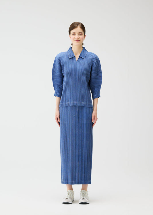 A model wears the PLEATS PLEASE ISSEY MIYAKE COTTON DENIM skirt.