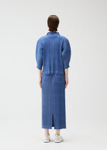 A model wears the PLEATS PLEASE ISSEY MIYAKE COTTON DENIM skirt.