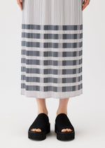 A model wears the PLEATS PLEASE ISSEY MIYAKE BUMPY BASKET bumpy-basket-skirt-charcoal.