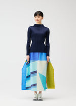 A model wears the PLEATS PLEASE ISSEY MIYAKE CITY COLLAGE clothing.