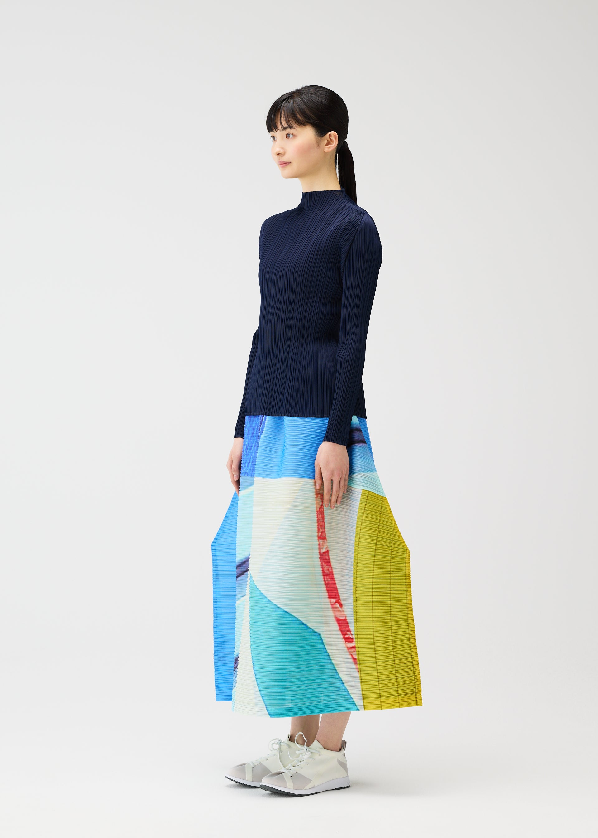 A model wears the PLEATS PLEASE ISSEY MIYAKE CITY COLLAGE clothing.