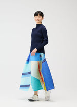 A model wears the PLEATS PLEASE ISSEY MIYAKE CITY COLLAGE clothing.