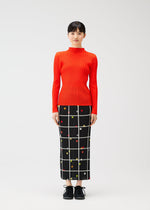 A model wears the PLEATS PLEASE ISSEY MIYAKE CROSSING DOTS skirt.