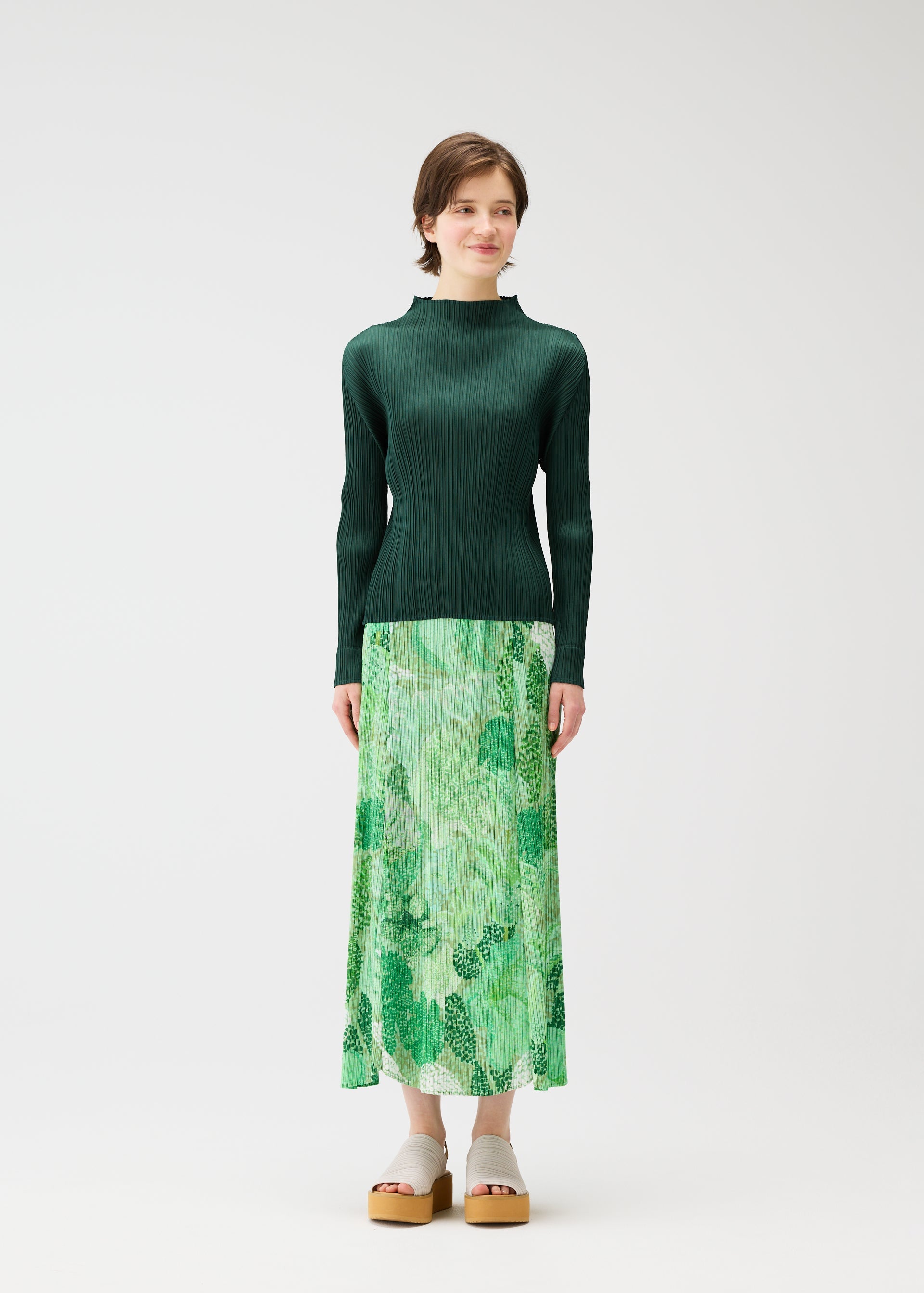 A model wears the PLEATS PLEASE ISSEY MIYAKE FOGGY FOREST skirt.