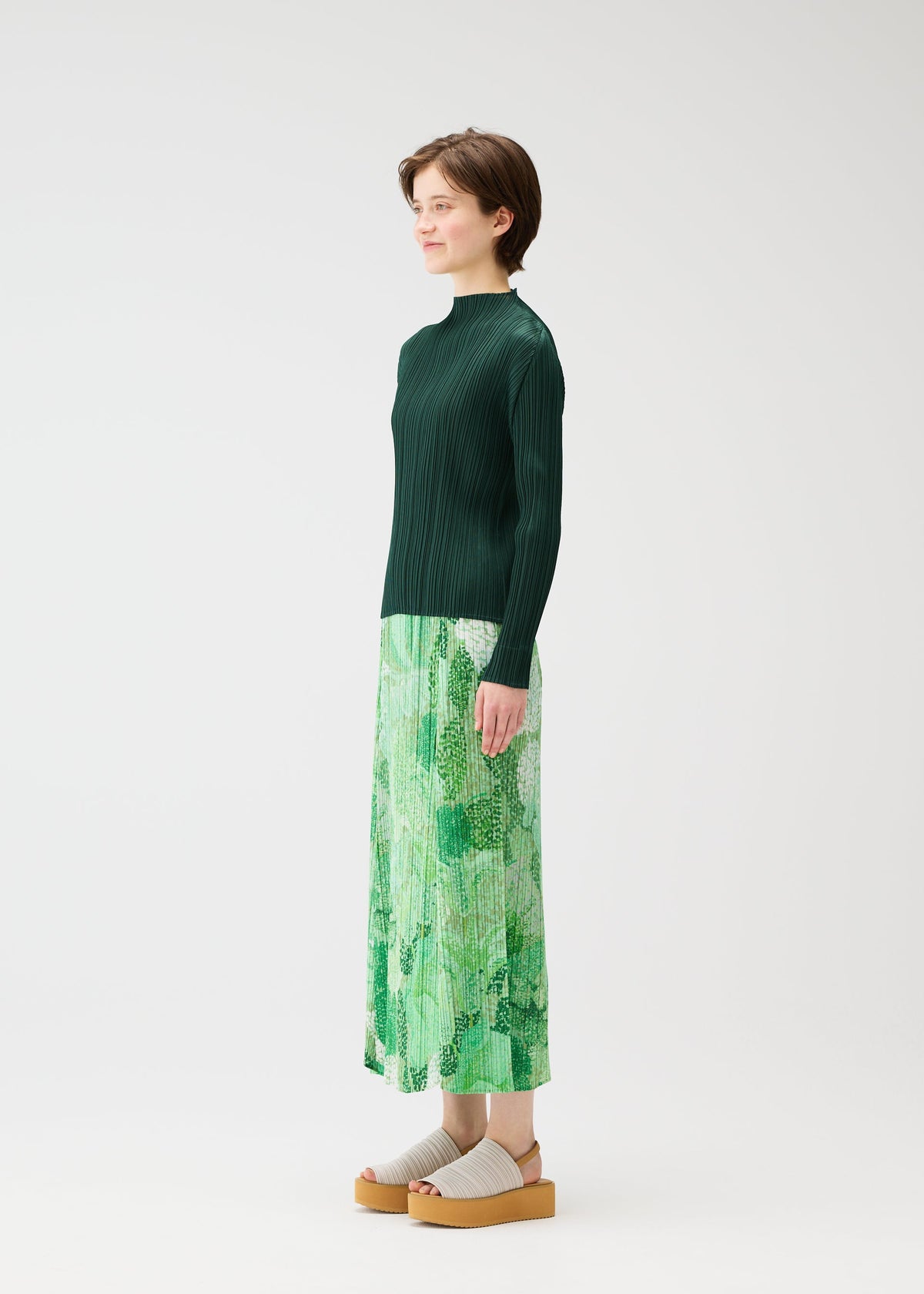 A model wears the PLEATS PLEASE ISSEY MIYAKE FOGGY FOREST skirt.