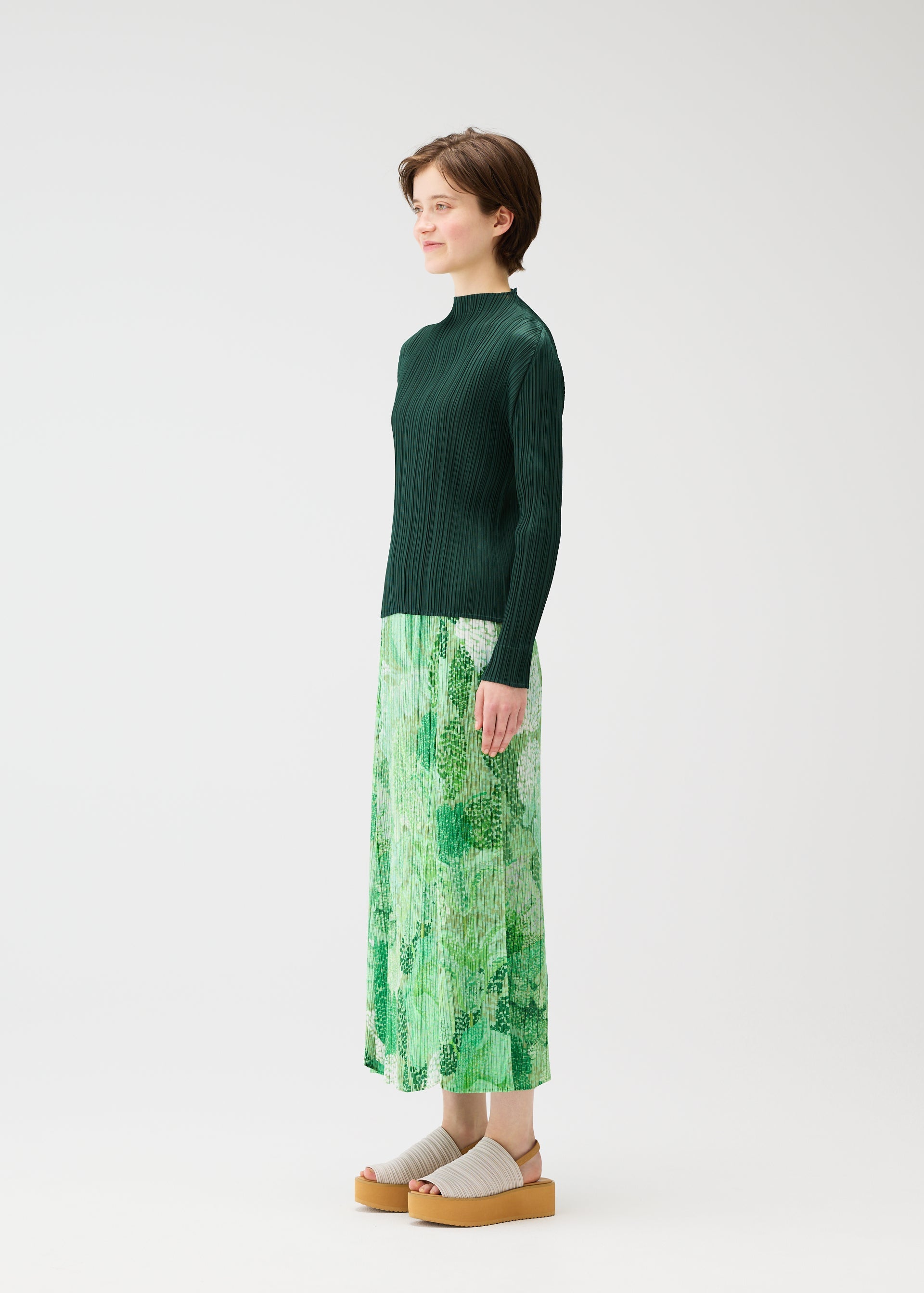 A model wears the PLEATS PLEASE ISSEY MIYAKE FOGGY FOREST skirt.