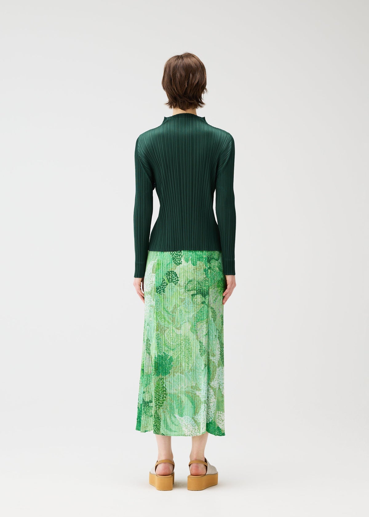 A model wears the PLEATS PLEASE ISSEY MIYAKE FOGGY FOREST skirt.