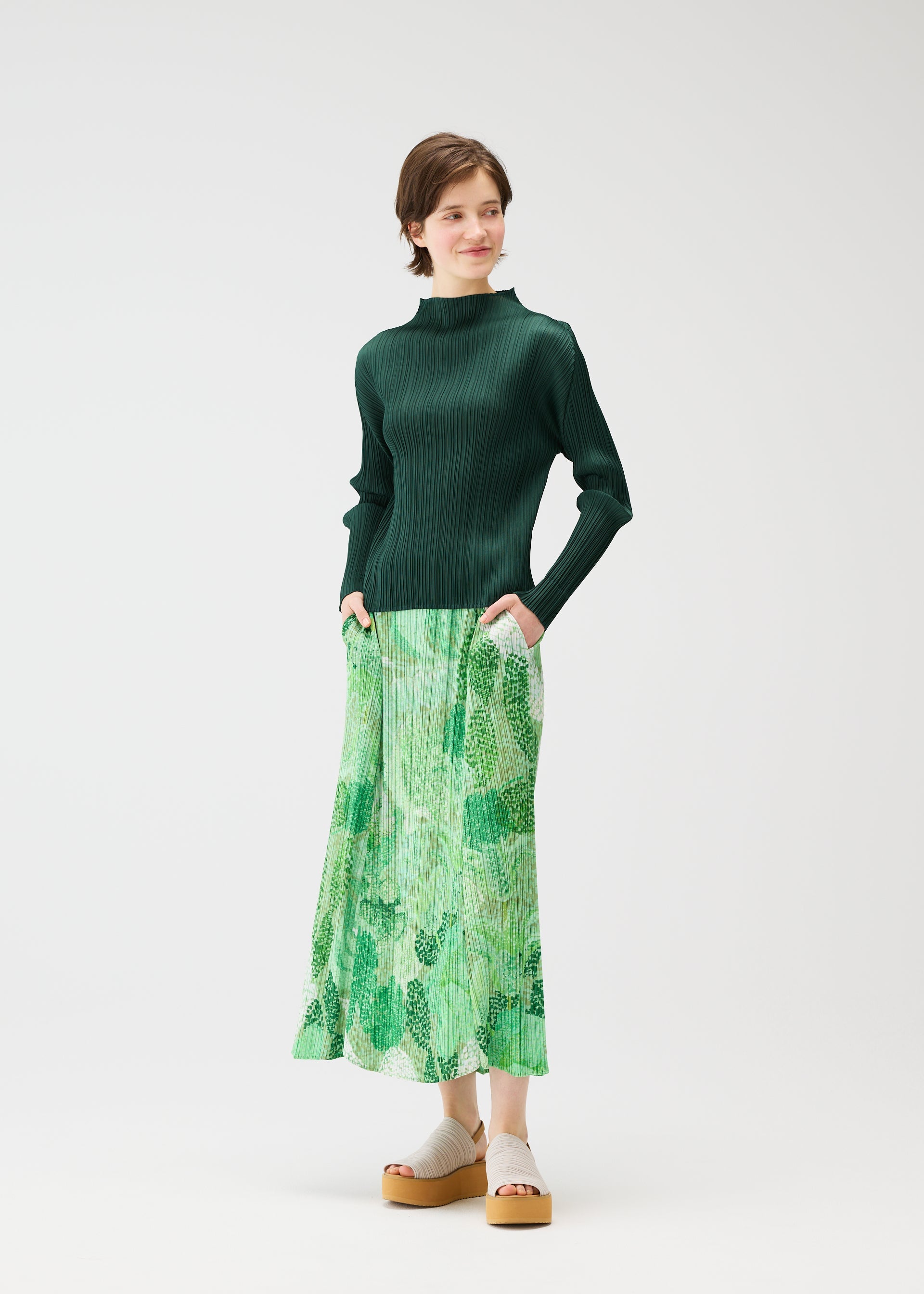 A model wears the PLEATS PLEASE ISSEY MIYAKE FOGGY FOREST skirt.