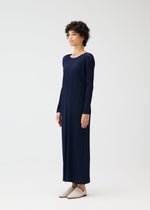 A model wears the PLEATS PLEASE ISSEY MIYAKE MONTHLY COLORS JANUARY clothing.