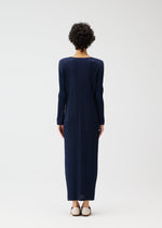 A model wears the PLEATS PLEASE ISSEY MIYAKE MONTHLY COLORS JANUARY clothing.