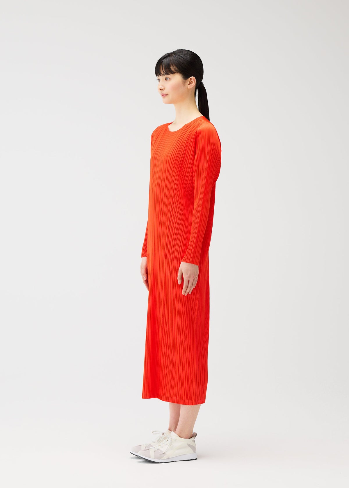 A model wears the PLEATS PLEASE ISSEY MIYAKE MONTHLY COLORS FEBRUARY dress.