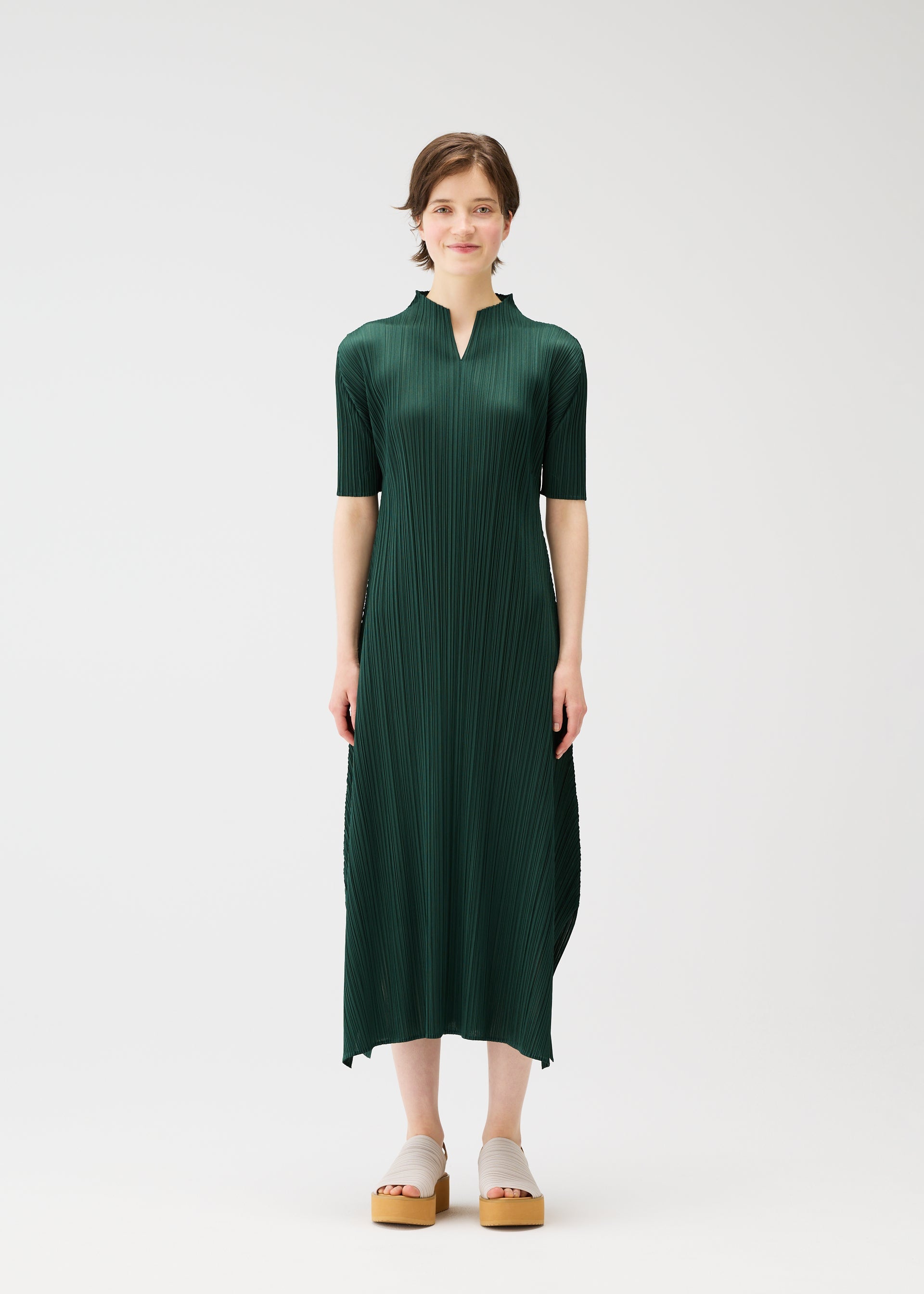A model wears the PLEATS PLEASE ISSEY MIYAKE MONTHLY COLORS MARCH dress.