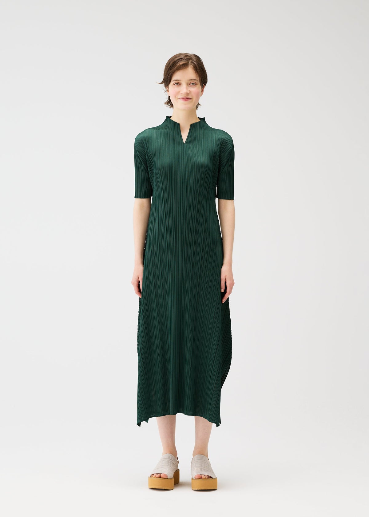 A model wears the PLEATS PLEASE ISSEY MIYAKE MONTHLY COLORS MARCH dress.