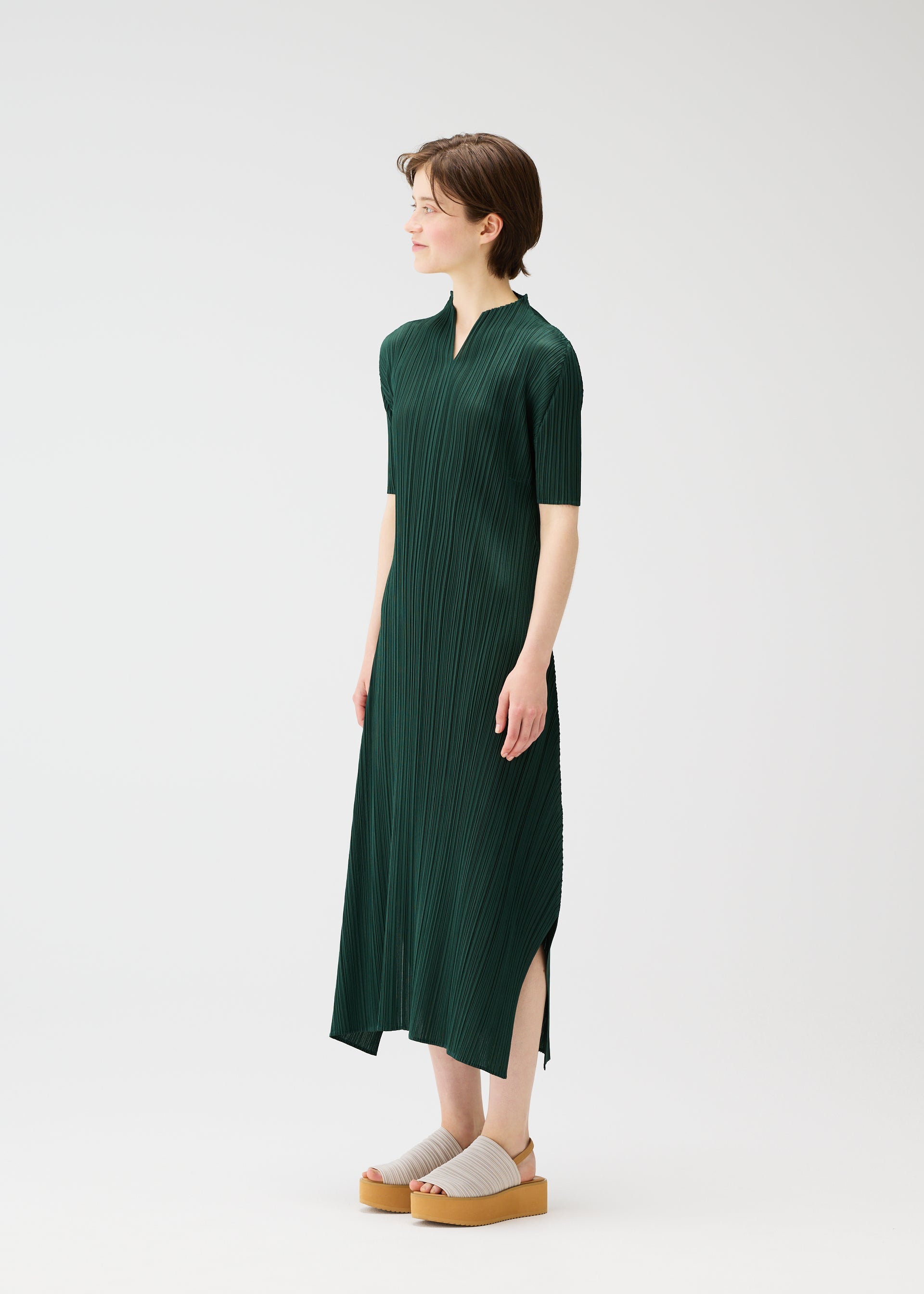 A model wears the PLEATS PLEASE ISSEY MIYAKE MONTHLY COLORS MARCH dress.
