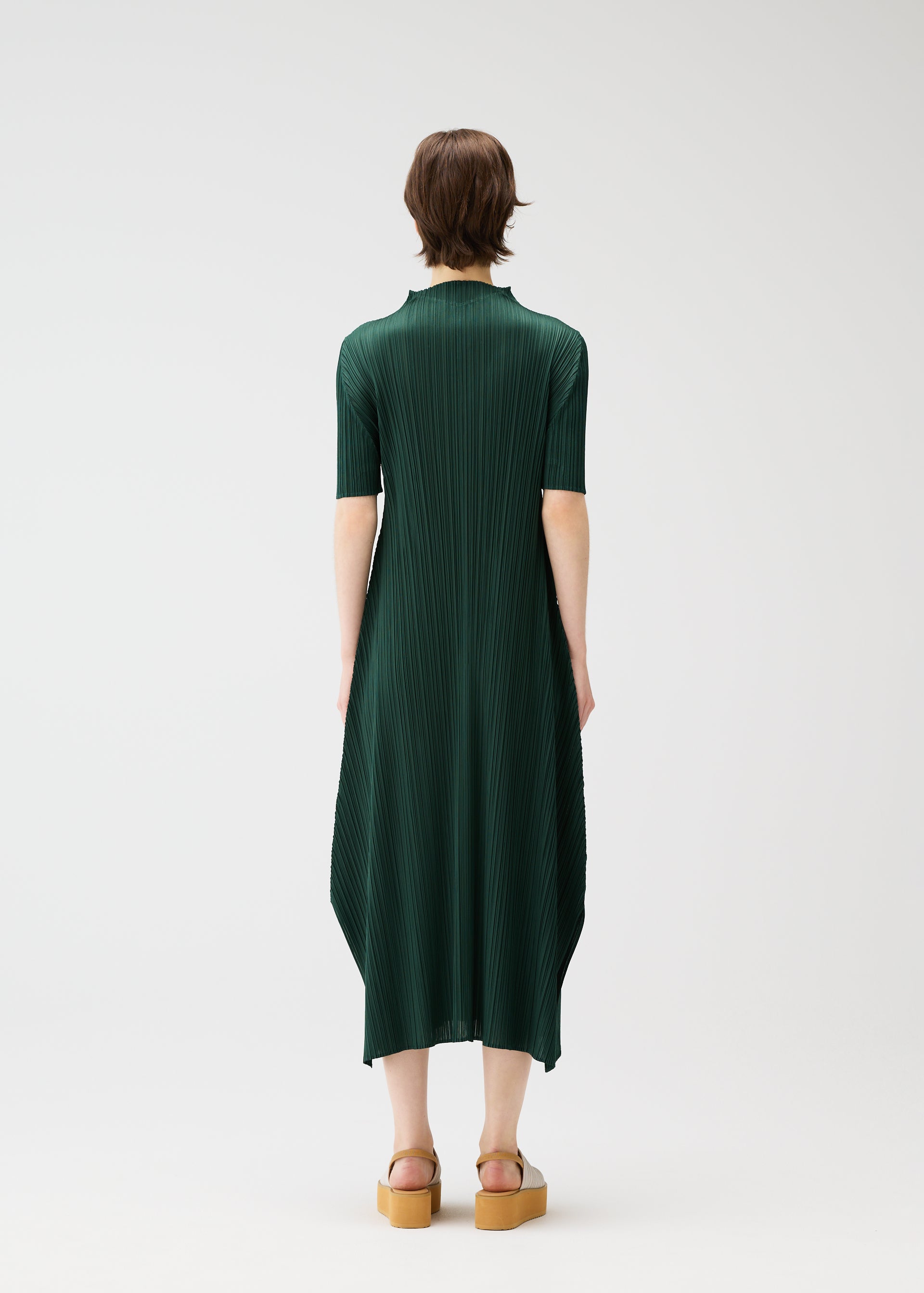 A model wears the PLEATS PLEASE ISSEY MIYAKE MONTHLY COLORS MARCH dress.