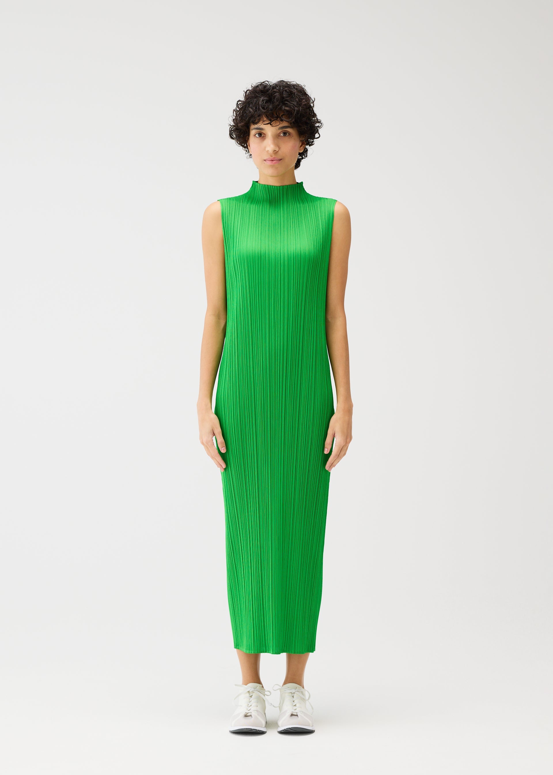 A model wears the PLEATS PLEASE ISSEY MIYAKE MONTHLY COLORS APRIL dress.